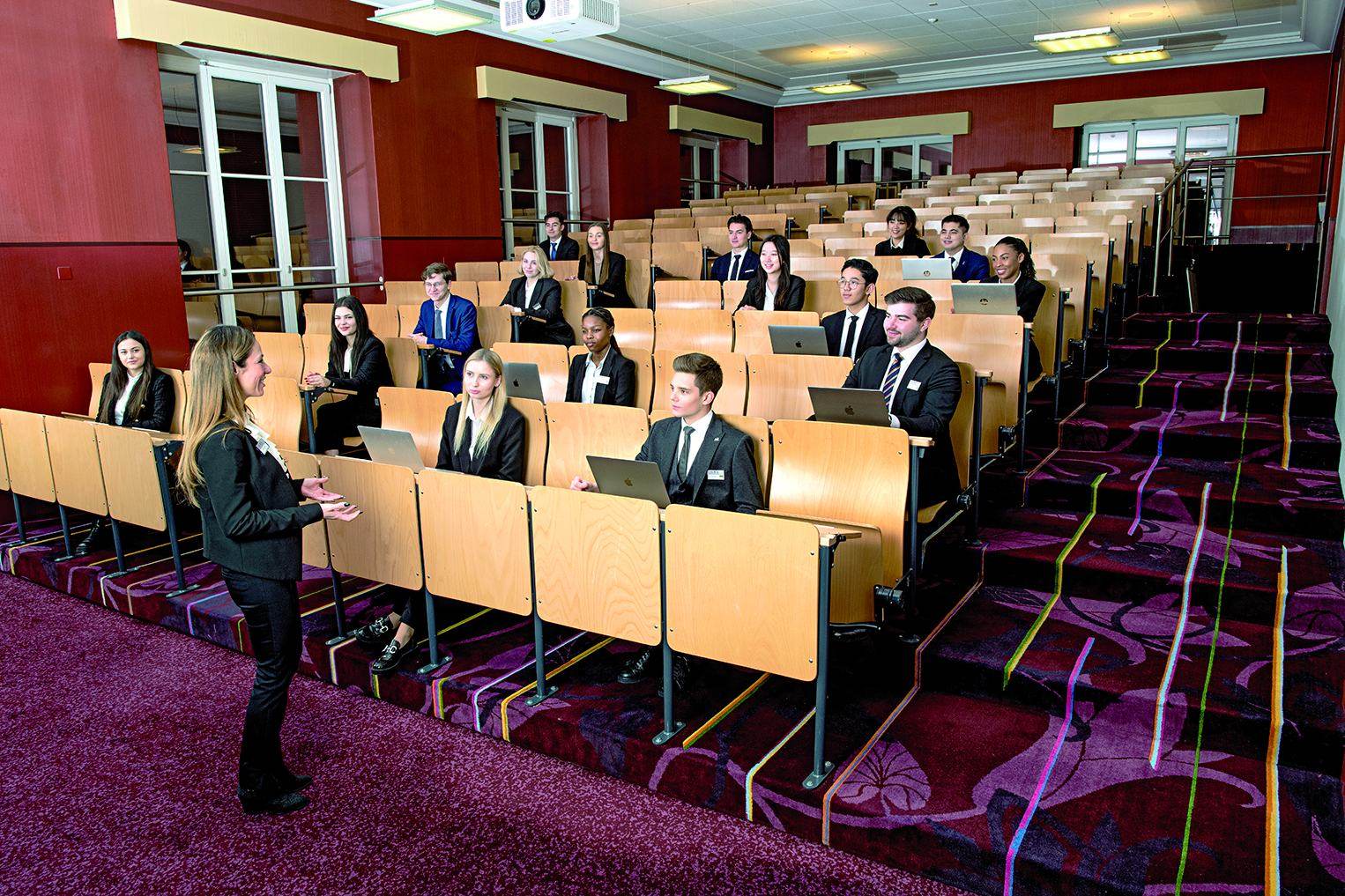 Students with laptops in the tiered BHMS lecture theatre