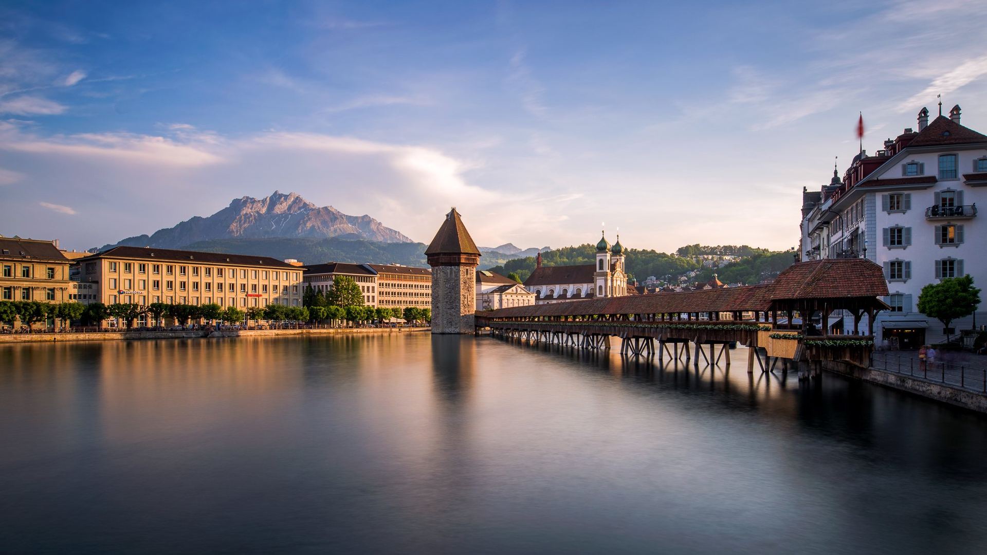 Chapel Bridge and water tower in Lucerne with Mount Pilatus behind